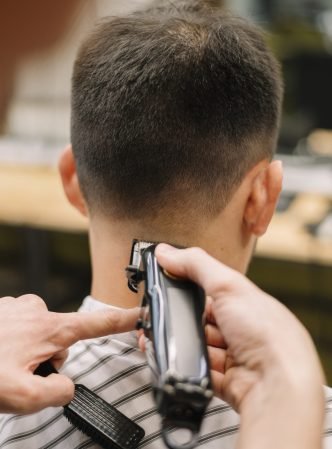 close-up-view-hairstilyst-giving-haircut